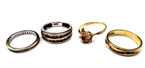 A diamond set full eternity ring, mounted with circular cut diamonds, a 9ct gold and diamond set ring in a wavy design, a white gold and diamond ring
