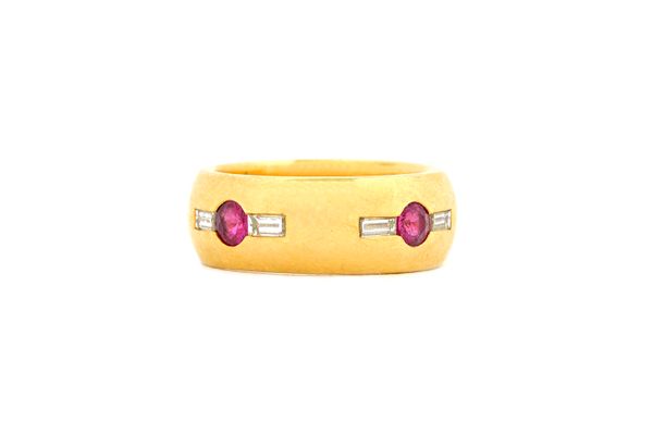 An 18ct gold, ruby and diamond ring, mounted with four circular cut rubies and with a baguette diamond, mounted at the side of each ruby, detailed T W