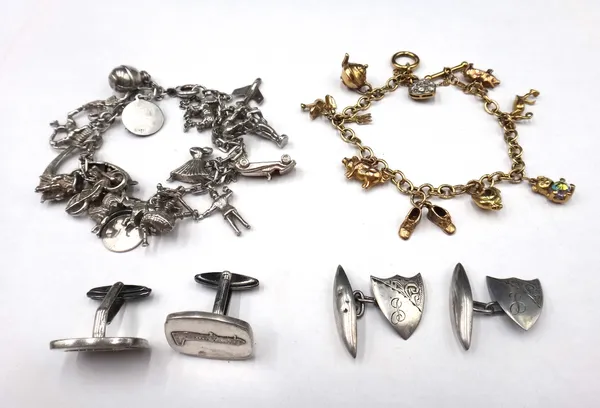 A 9ct gold oval link charm bracelet, with a T bar and circular loop shaped clasp, fitted with nine mostly 9ct gold charms, including; two pigs, a teap