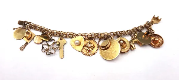 A gold multiple link bracelet, on a snap clasp, detailed 14 K, fitted with a variety of gold and other charms and pendants, including; a poodle, detai