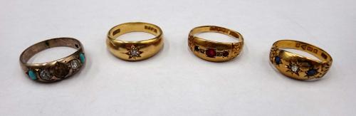 An 18ct gold, sapphire and diamond three stone ring, Chester 1916, an 18ct gold and diamond single stone ring, star gypsy set, with a cushion shaped d