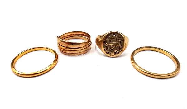 A 22ct gold plain wedding ring, Birmingham 1935, a gold wedding ring, detailed GALT 18B KT, a gold signet ring, monogram engraved and a gold ring, of