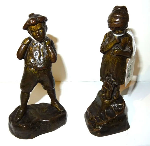 An Austrian bronze figure of a young boy, signed 'R. Kainz', modelled with a backpack on a naturalistic base, 11.5cm high and another German bronze of