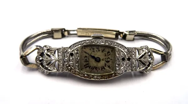 A platinum cased and diamond set lady's dress wristwatch, with an oval jewelled lever movement, the silvered dial, with Arabic numerals, the case and