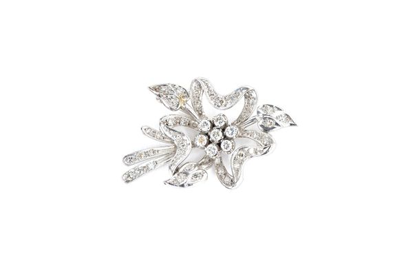 A diamond brooch, designed as a floral and foliate spray and with a seven stone cluster to the centre, mounted with circular cut diamonds, length 4cm.
