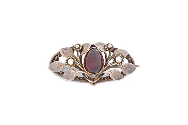 A Victorian vary coloured agate set brooch, in a shaped oval openwork design, a carbuncle garnet set brooch, decorated with foliate motifs and a circu