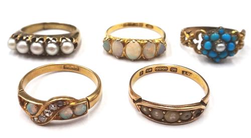 An 18ct gold ring, mounted with a row of five oval opals, graduating in size to the centre stone, Birmingham 1902, a gold ring, mounted with a row of