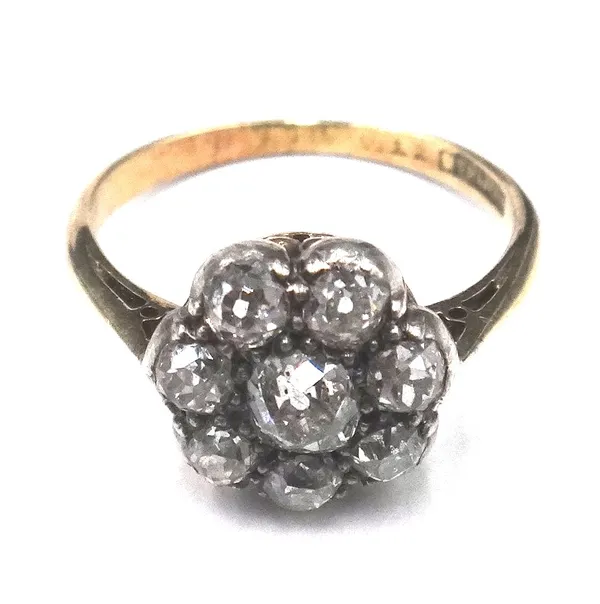 A gold and diamond eight stone cluster ring, mounted with the principal cushion shaped diamond at the centre, in a surround of seven smaller cushion s