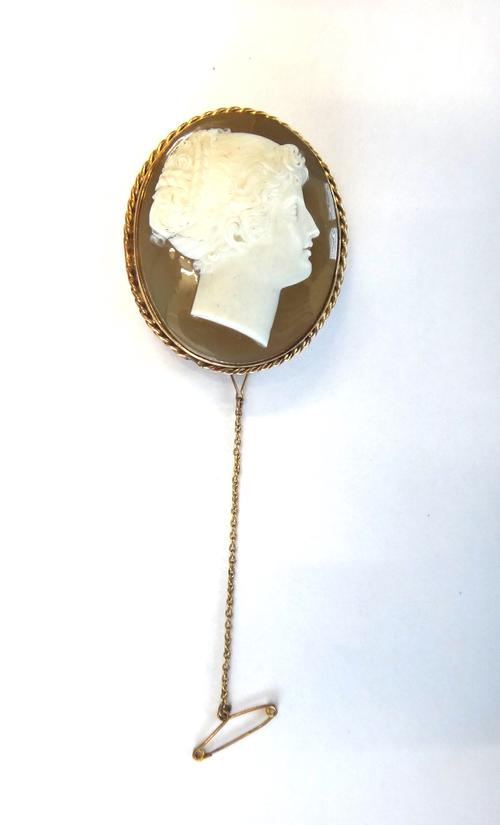 A gold mounted carved agate cameo brooch, carved as the portrait of a classical lady, within a ropetwist surround, detailed to the back LV 9 CT, fitte