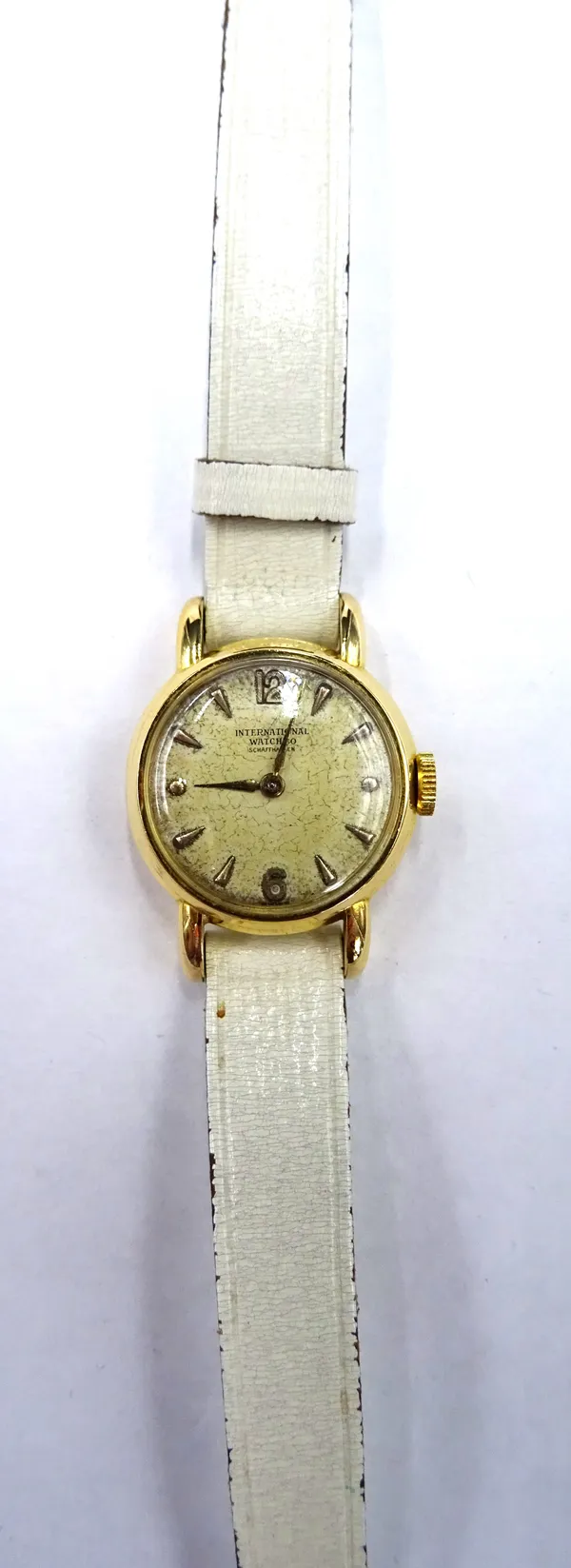 An International Watch Company Schaffhausen gold circular cased lady's wristwatch, circa 1950, with a signed jewelled lever movement, detailed within