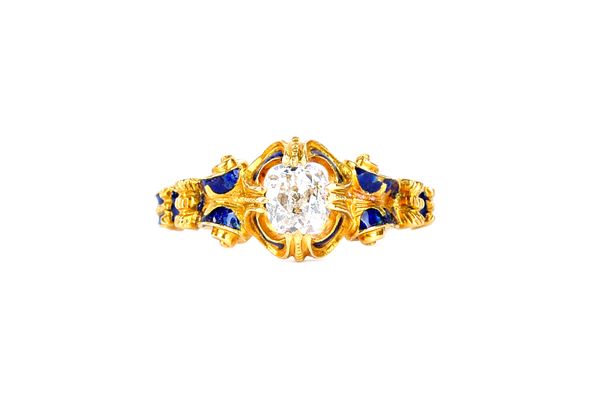 A Victorian gold, diamond set and blue enamelled ring, in a scrolling design, claw set with a cushion shaped diamond, ring size K, with a box. Illustr