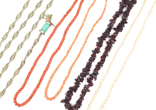 Two single row necklaces of coral beads, a single row necklace of tumbled garnet beads, a gilt metal necklace, with two pale green paste cylindrical d