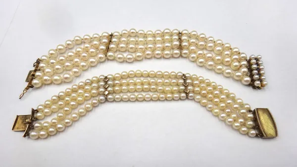 A four row bracelet of uniform cultured pearls, on a gold, sapphire and cultured pearl snap clasp, detailed 14 K, length 19cm and a four row bracelet