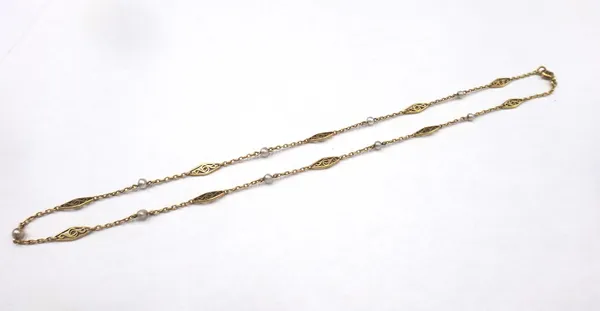 A gold and seed pearl set necklace, circa 1910, in an oval link design, spaced with scroll pierced links, alternating with seed pearls, on a boltring