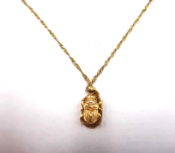 A gold pendant formed as an Egyptian scarab beetle, with a gold neckchain, on a boltring clasp, combined weight 4.1 gms.