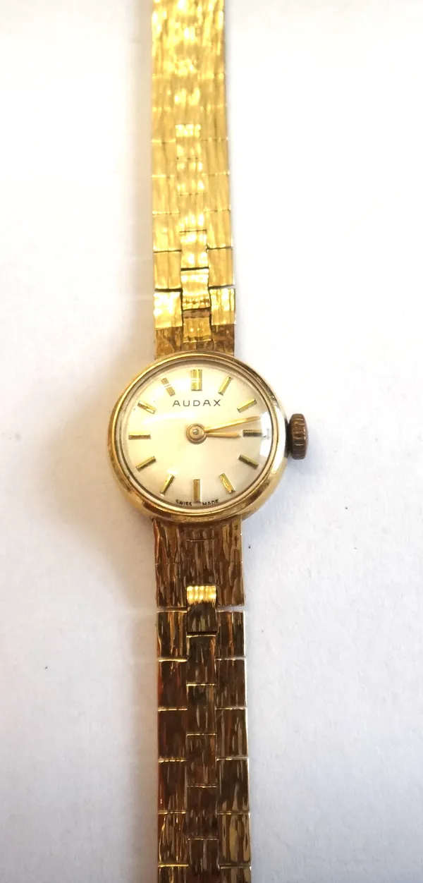 An Audax 9ct gold lady's bracelet wristwatch, the signed silvered dial with gilt baton numerals, on a brick link bracelet, having a bark textured fini
