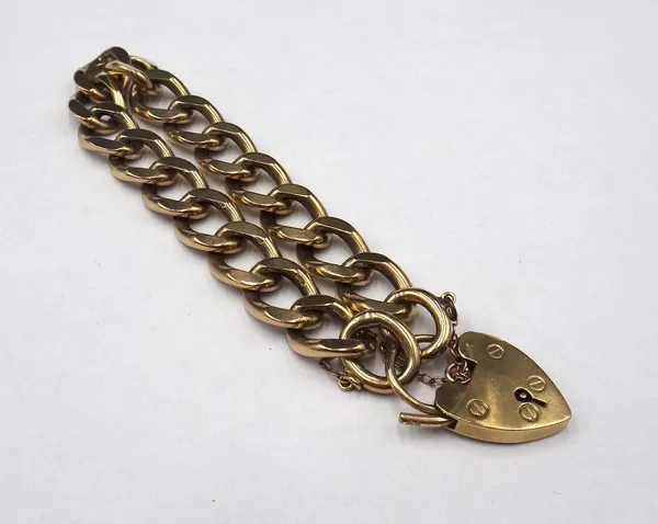 A 9ct gold faceted curb link bracelet, on a 9ct gold heart shaped padlock clasp, weight 43.7 gms.
