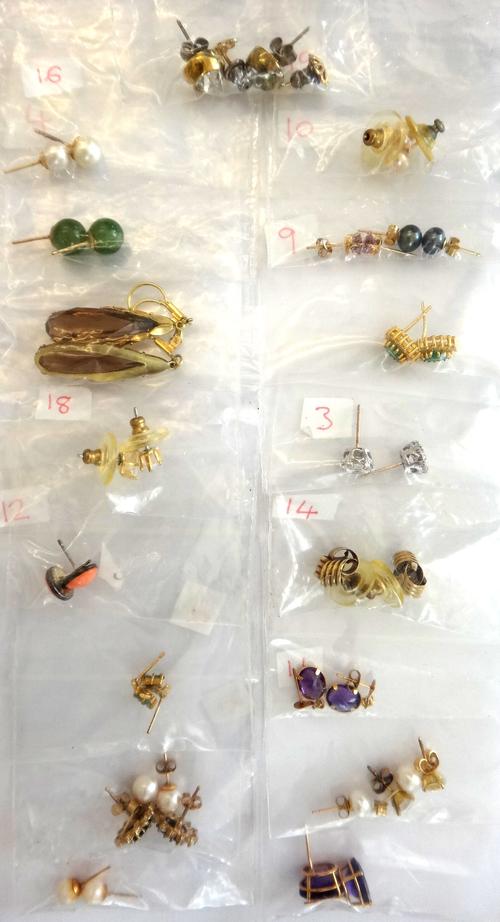 A pair of 18ct gold, emerald and diamond set oval cluster earstuds, with post fittings to the backs, (the butterfly clips lacking) and twenty further