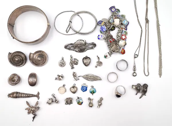 Mostly silver jewellery, comprising; a charm bracelet, fitted with a variety of mostly enamelled shield shaped charms, sixteen pendants and charms, fo