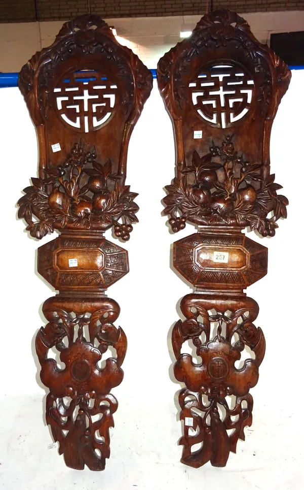 A pair of Chinese wooden panels, pierced and carved with bats, fruit, flowers and bamboo, 100cm high, (2).  M4