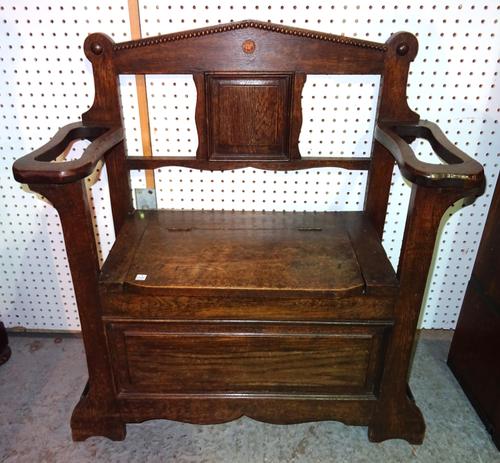 A mid-20th century oak hall bench, with lift top seat flanked by umbrella stand, 79cm wide x 86cm high.  M4