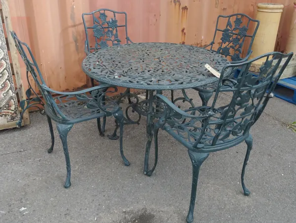 A 20th century green painted metal circular garden table with vine decoration and a set of four matching open armchairs, 98cm wide x 70cm high (5).  O
