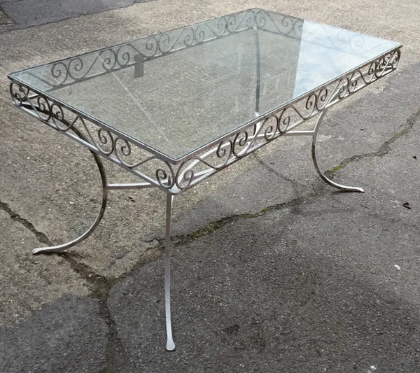 A 20th century white painted metal rectangular garden table with inset glass top on outswept supports. 138cm wide x 74cm high.  OUT