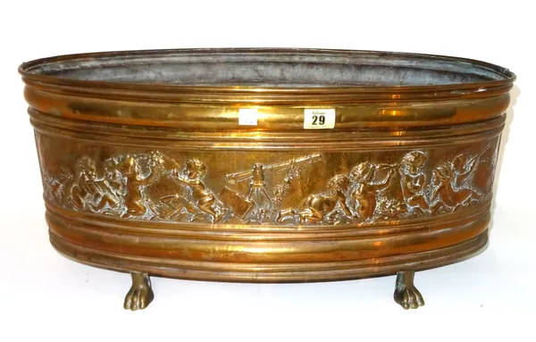 A Victorian oval copper jardiniere, embossed with a band of allegorical cherubs, with a tin liner, on four lion paw feet, 57cm wide.  I5