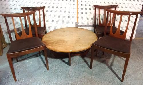 A 20th century G-Plan style circular coffee table on 'X' frame base, 90cm wide x 38cm high and a set of four G-plan teak stick back dining chairs, (5)