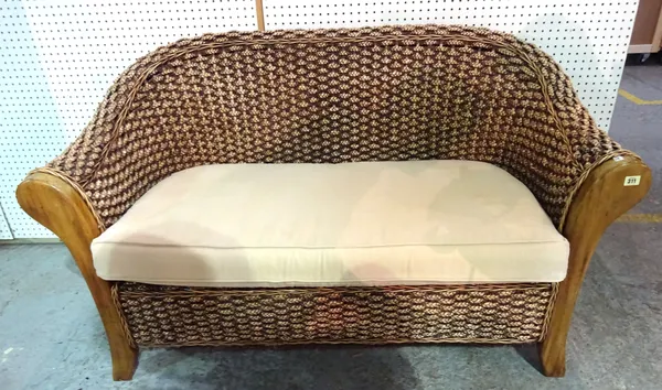 A 20th century mahogany framed rattan two seat sofa on block supports, 109cm wide x 179cm high.  BAY 3