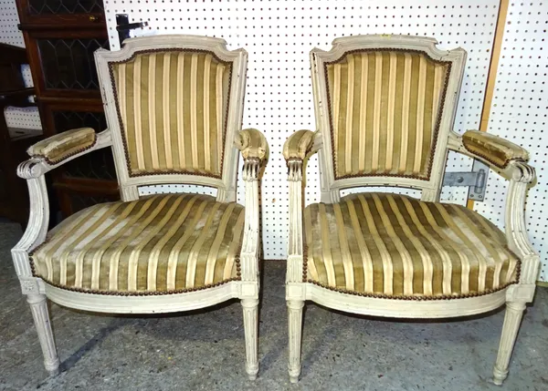 A pair of Louis XVI style grey painted open armchairs on fluted supports, 61cm wide x 89cm high (2).  BAY 3