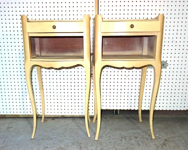 A pair of early 20th century French white painted bedside tables with single drawer and galleried top on tapering cabriole supports, 36cm wide x 70cm