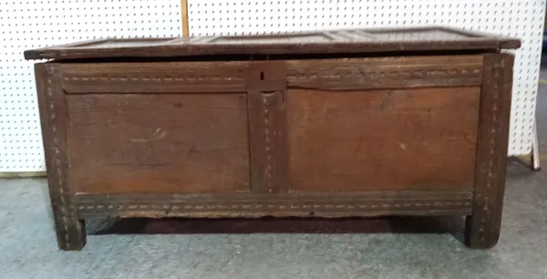 A 17th century and later oak triple panel coffer with carved decoration, 116cm wide x 54cm high.  L8