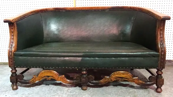 A 20th century oak framed two seat sofa with faux studded green leather upholstery, 123cm wide.   L7