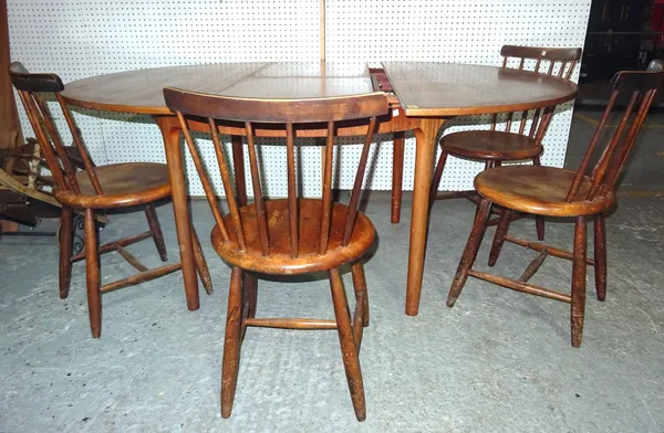 A.H Macintosh; a 20th century teak circular extending dining table with one integral leaf, 124cm wide x 75cm high, 160cm fully extended and a set of f