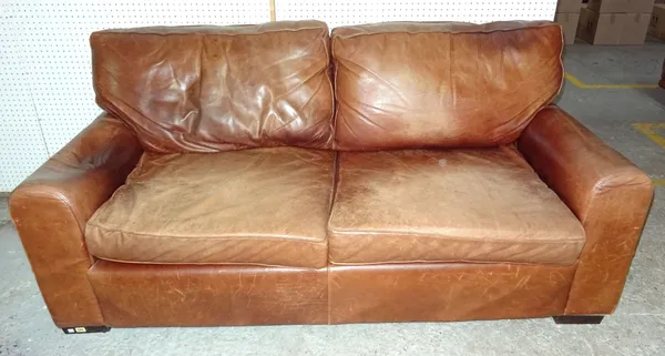 A brown aniline leather three seater sofa, raised on wooden square feet, 196cm wide.  BAY 1
