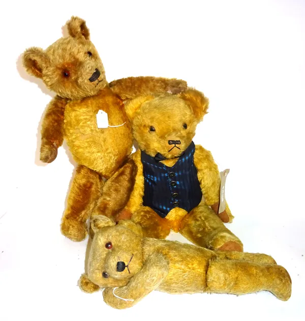 Three early 20th century teddy bears, possibly 'Merrythought', with golden fur and jointed limbs, the largest 58cm high, (a.f), (3).  S2T