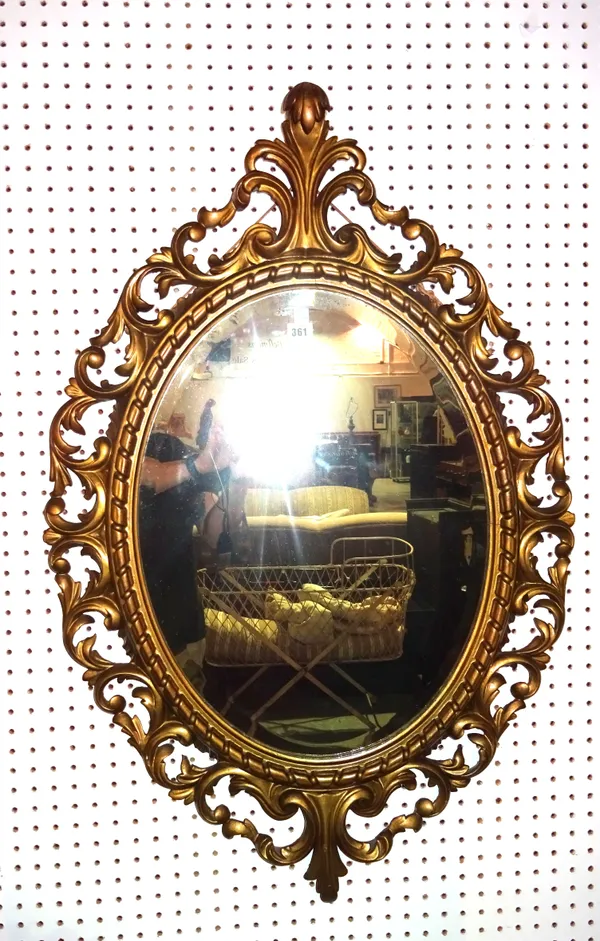 A 20th century gilt framed mirror with scroll decoration, 69cm wide x 103cm high.   A6