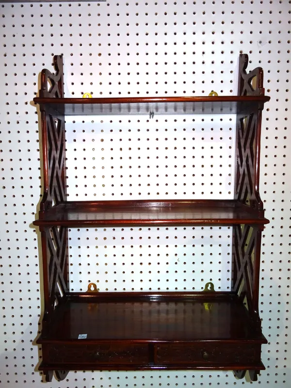 A 20th century mahogany fret cut three tier hanging wall shelf with two short drawers, 49cm wide x 90cm high.   C10