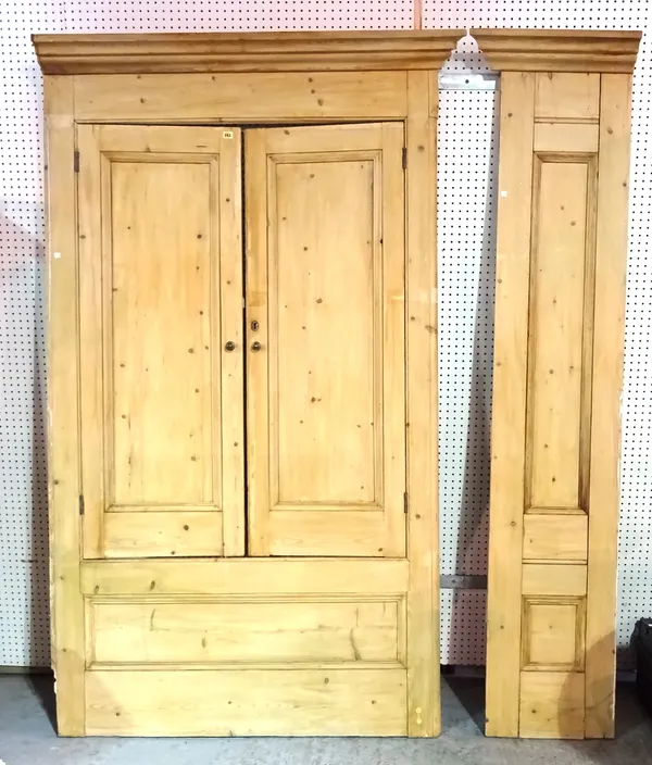 A 20th century pine corner unit with panelled doors, 130cm wide x 230cm high.   L7