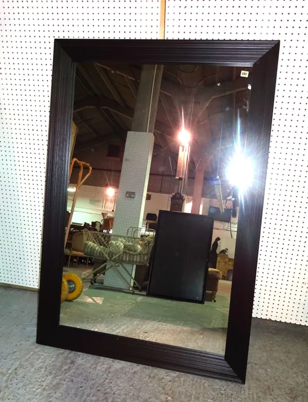 A 20th century Flexform ebonised rectangular mirror, 103cm wide x 150cm high.  L10