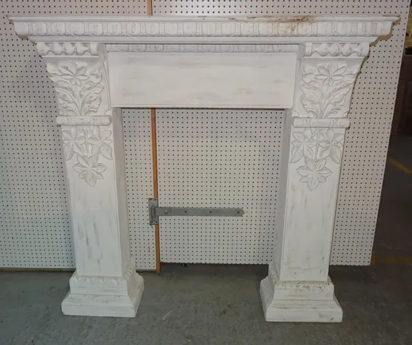 A 20th century white painted fire surround with floral and egg and dart decoration, 140cm wide x 139cm high, aperture 78cm wide x 104cm high.  EXTRA