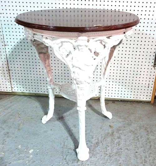 A white painted cast iron pub table with circular mahogany top, 53cm wide.  BAY 1