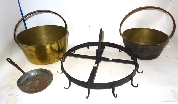 A similar pair of brass jam pans with swing handles and a wrought iron game hanging rack.  S2T