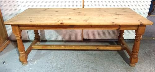 A rectangular pine kitchen table, on turned supports, 82cm wide x 190cm long x 75cm high.  BAY 2