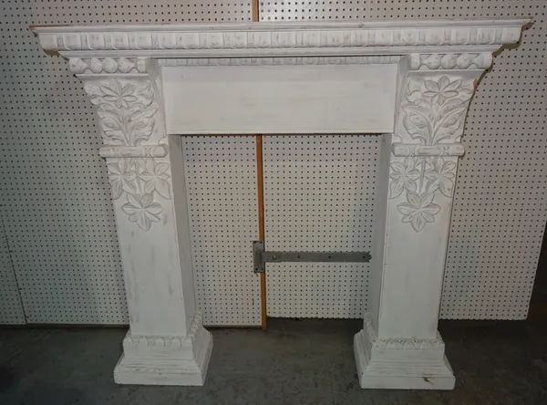 A 20th century white painted fire surround with floral and egg and dart decoration, 140cm wide x 139cm high, aperture 78cm wide x 104cm high.  EXTRA