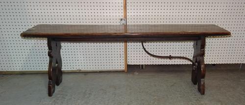 An early 20th century Spanish oak rectangular bench on trestle supports, lacking one metal bracket, 135cm wide x 47cm high.  BAY 2