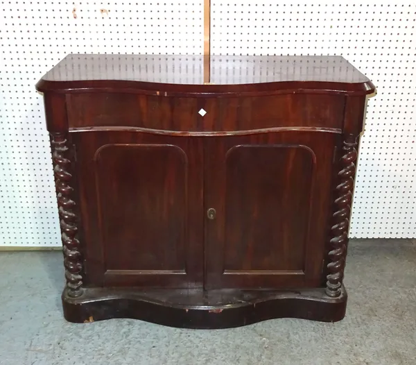A Victorian mahogany serpentine cabinet with single drawer over panelled doors flanked by barleytwist column supports, 106cm wide x 90cm high.  A8