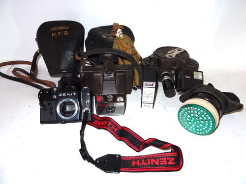 A quantity of early 20th century cameras, comprising; Filmo, Sigma, cases and sundry, (qty).  S3B
