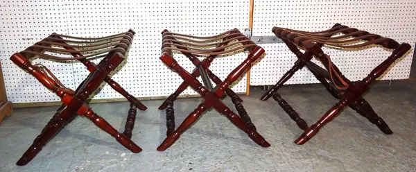 Pakeen; a set of three 20th century mahogany and leather luggage stands, 63cm wide x 50cm high, (3).  I4